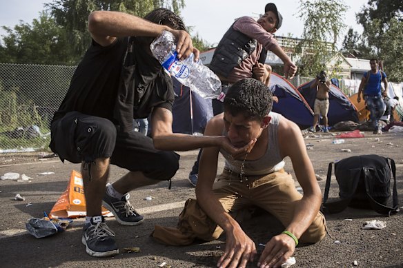 A refugees eyes are washed out after being irritated with tear gas and pepper spray at a a violent clash with Hungarian police at the Horgos border crossing in Serbia. 
