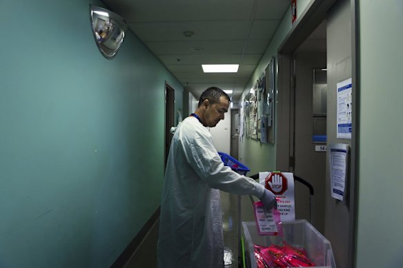 Sanjay Adhikari delivers samples that are to be tested for coronavirus.