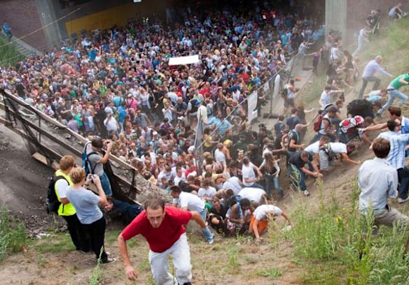 Revellers rush up a hill after panic broke out during the Love Parade in Duisburg, western Germany.