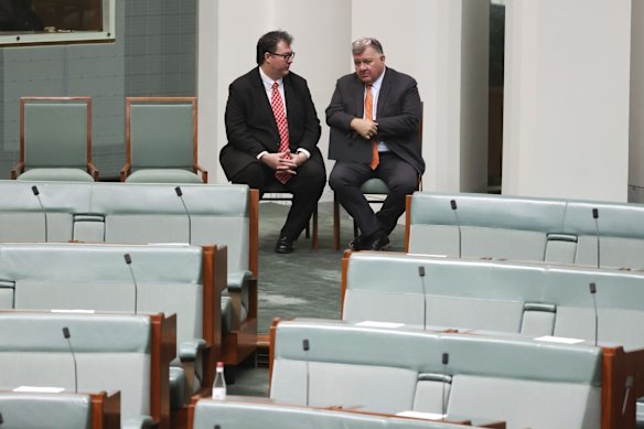 Nationals backbencher George Christensen in discussion with crossbench MP Craig Kelly at the back of the chamber on Monday 24 May.