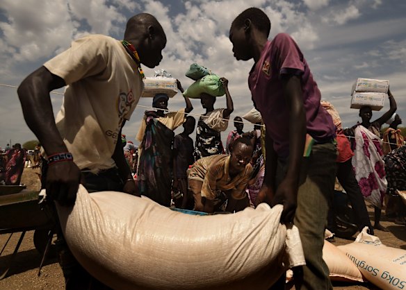 Rationed food and non food items are collected by people living in the UNMISS Bentiu Protection of Civilians site, Unity State, South Sudan.