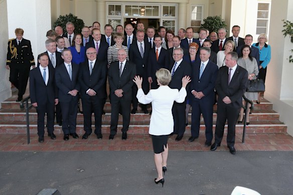 Minister for Foreign Affairs Julie Bishop helps organise the group photo after the swearing-in at Government House in Canberra on Monday 21 September 2015. Photo: Alex Ellinghausen