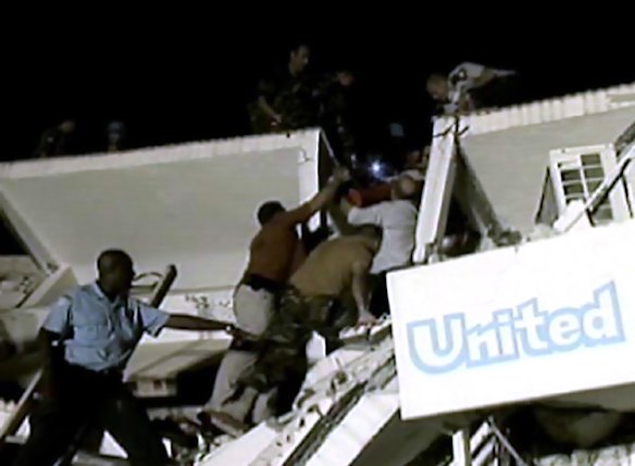 Peacekeepers look for survivors under the rubble of the headquarters of the United Nations (UN) Stabilisation Mission.