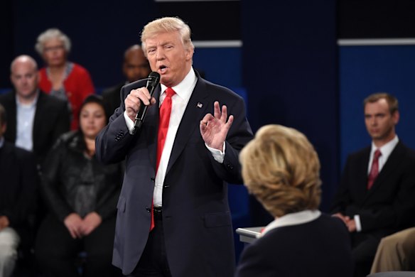 Republican presidential nominee Donald Trump speaks as Democratic presidential nominee Hillary Clinton listens during the second presidential debate.