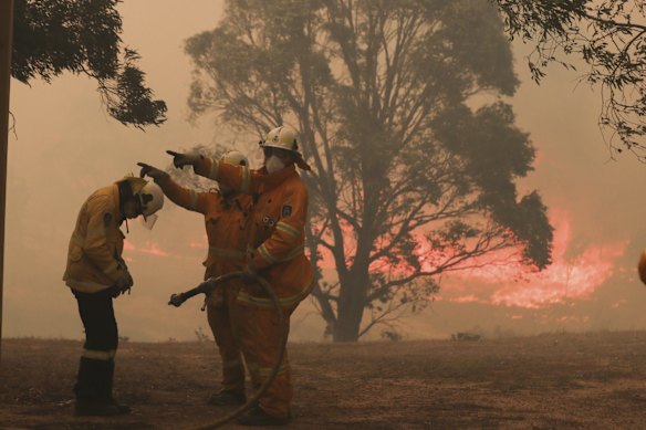 RFS firefighters working to protect properties as the North Black Range bushfire threatens properties at Bombay, NSW.