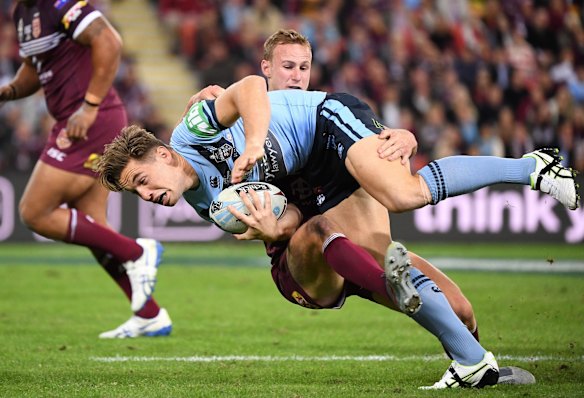 Daly Cherry-Evans of the Maroons tackles Cameron Murray of the Blues.