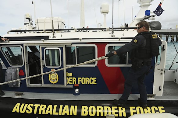Australian Border Force (ABF) marine tactical officer Michael Kingston on a fast response boat patrolling off Thursday Island.