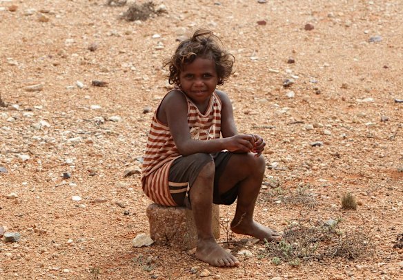 A young boy waits for entertainer, Jessica Mauboy to perform at Watson on The Nullabor Plain in South Australia for children from Oak Valley Aboriginal School.