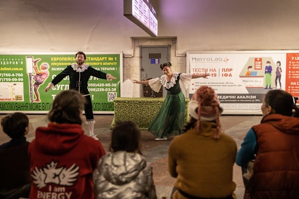 Children sheltering in a subway turned into a makeshift bomb shelter watch performers who came to do a puppet show in Kharkiv, Ukraine. 