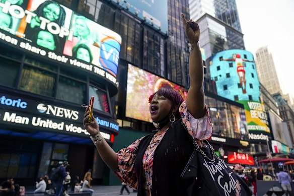AniYa A motions as she walks through Times Square in New York, while talking on her cell phone after a Minnesota jury found Former Minneapolis police officer Derek Chauvin guilty of murder and manslaughter in the death of George Floyd.