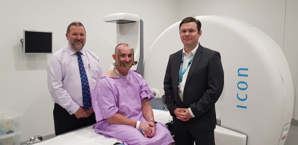 Neurosurgeon Dr Bruce Hall, brain cancer patient Robert Wetherspoon and Radiation Oncologist  Dr Mark Pinkham in front of the Princess Alexandra Hospital's Gamma Knife machine.