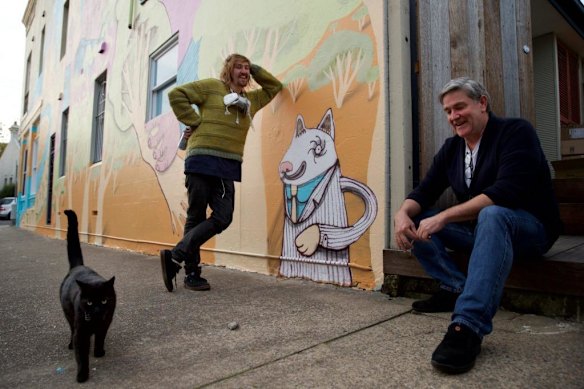 Street artist Birdhat (left) and Victoria and Hobbs cafe owner Dale with the recently completed mural. Marrickville Council is pairing street artists with homeowners to make giant murals on their walls and deter graffiti artists.