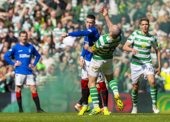 Fiery: Rangers’ Ryan Kent clashes with Celtic captain Scott Brown during a combustible Old Firm derby at Parkhead in 2019.
