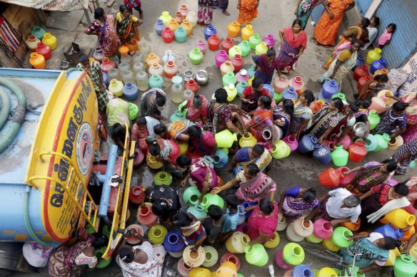 Indians stand in queues to fill vessels filled with drinking water from a water tanker in Chennai, capital of the southern Indian state of Tamil Nadu.