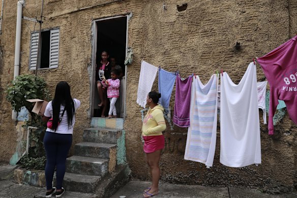 Volunteer members of Associacao Acao Comunitaria Nova Heliopolis distribute easter eggs in Heliopolis favela during the Coronavirus (COVID - 19) in Sao Paulo, Brazil.
