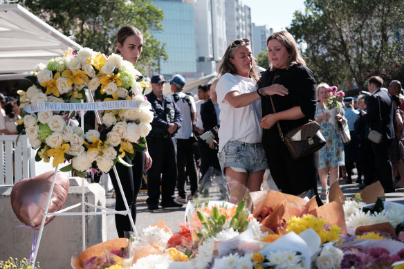 Mourners grieve as the pile of floral tributes at Bondi Junction grows.