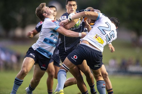 The Waratahs' Will Harrison and Richard Woolf combine to stop the Brumbies' Chance Peni.
