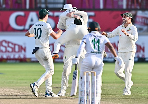 Happy days: Australia celebrate as Proteas captain Temba Bavuma is dismissed.