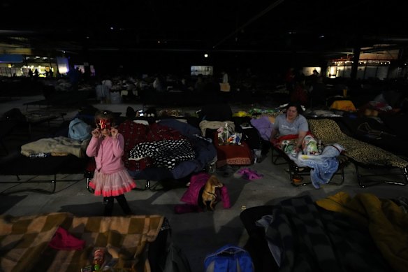 Ukrainians rest at an exhibition hall, turned into a refugee center in Nadarzyn, near Warsaw, Poland.