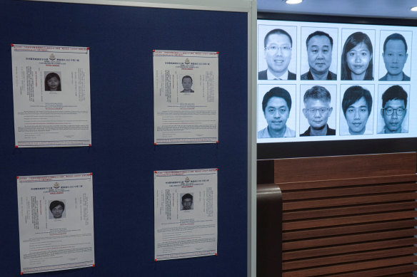 Photos of eight activists who have been issued arrest warrants over national security are displayed during a press conference in Hong Kong,