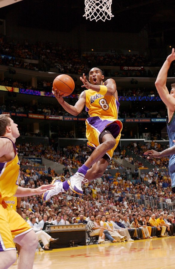 2004: Kobe Bryant of the Los Angeles Lakers drives to the basket past the Minnesota Timberwolves defense in Game Six of the Western Conference Finals during the 2004 NBA Playoffs at Staples Center in Los Angeles, California. 