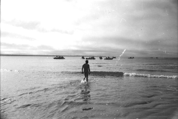 At 11.00 am 39 year old used car dealer Doug Mew enters the water at Point Lonsdale to start his swim across The Rip to Point Nepean. Waiting offshore are some of the 20 or so small boats to escort him across the Heads in Port Phillip Bay, 1971. 