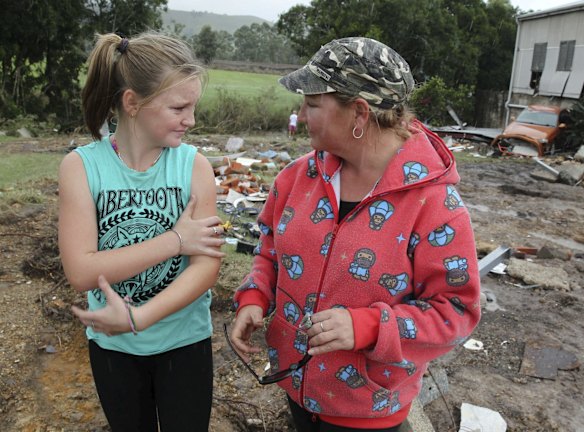 Angie Taylor and daughter Taryn, at the site if their house, which was
washed away by flood waters in Dungog, NSW.