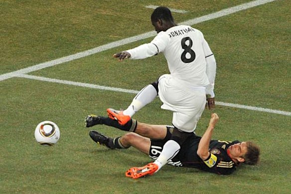 Ghana's defender Jonathan Mensah (up) tries to get the ball past Germany's defender Philipp Lahm.