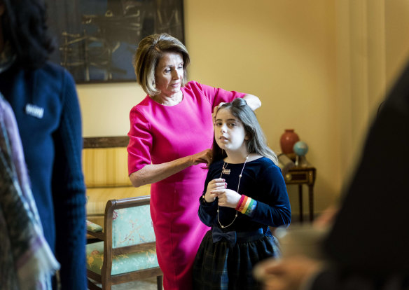 Nancy Pelosi fixes the hair of granddaughter Bella Kaufman in the Speaker's Office on Capitol Hill. 