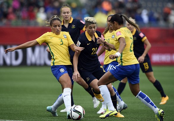 Australia's forward Michelle Heyman (C-23) vies with Brazil's defenders Fabiana (R) and Monica (L).