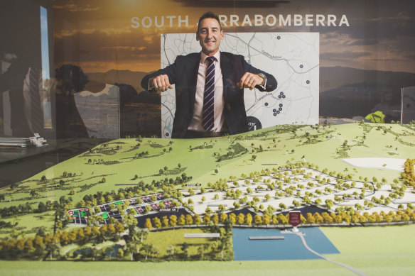 Village Building Co. chief executive Travis Doherty with a model of the master plan for the 1250-home estate.