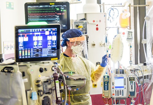 ICU nurse at work on a patient.