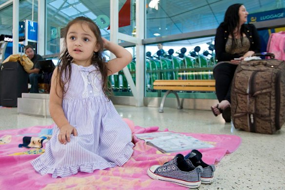 Qantas grounds worldwide fleet. Pictures show Sydney Domestic Airport. Three year old Nevaeh Fetoai and mum Rebecca Morrison from Brisbane are stranded with no where to go. Photo by Steve Lunam