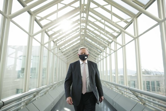 Opposition Leader Anthony Albanese wearing a Rabbitohs mask exits the press gallery at Parliament House in Canberra.