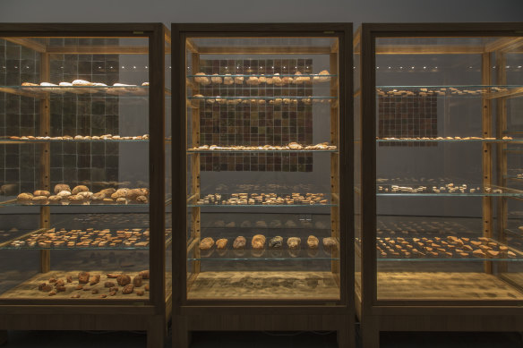 Objects are placed within specially constructed vitrines for Simryn Gill's Domino Theory, 2014.