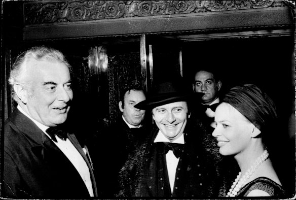 Gough Whitlam talks with Barry Humphries and his escort Miss Roslyn Mackrell of Sydney in 1974.