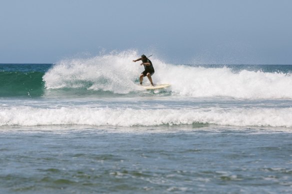 Surfing at Impossibles Beach on the Bukit Peninsula in Bali.