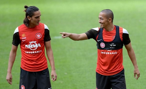 Jerome Polenz, left, and Shinji Ono chat during a Western Sydney Wanderers A-League training session at Suncorp Stadium.