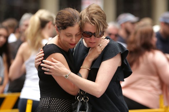 Women comfort each other in Martin Place on December 16, 2014 in Sydney, Australia.