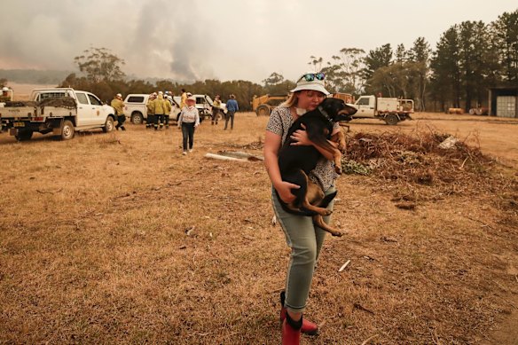 Bombay resident Tiana Hockey evacuates her dog Maddie as the North Black Range bushfire threatening properties at Bombay, NSW.