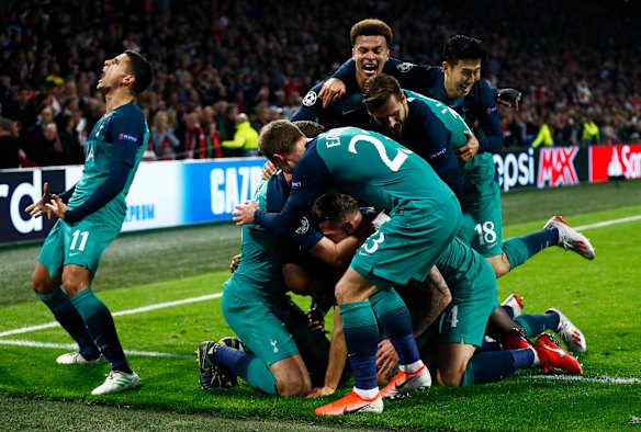Triumphant: Tottenham players following Lucas Moura's third and decisive strike.