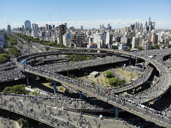 Argentina soccer fans converge on the highways during a homecoming parade for the players who won the World Cup title, in downtown Buenos Aires, Argentina.