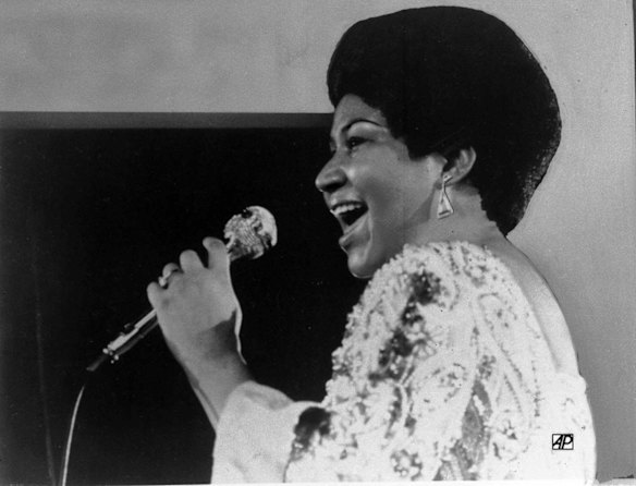 In this Jan. 28, 1972 file photo, vocalist Aretha Franklin sings a few notes into microphone.