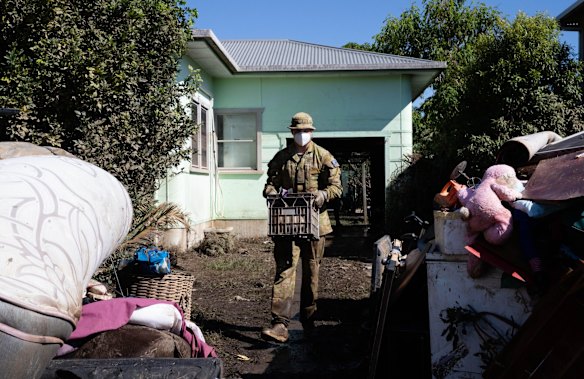 Members of the ADF help locals to clear their flood damaged homes in Broadwater after the waters receded in the Northern Rivers region of NSW. 