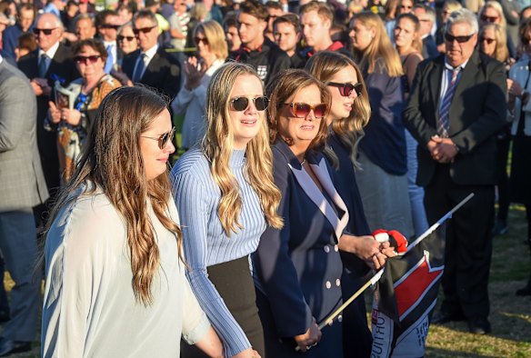 Fans pay tribute one last time as Danny Frawley's hearse does a lap of honour of Morabbin Oval with wife Anita and three daughters walking behind.