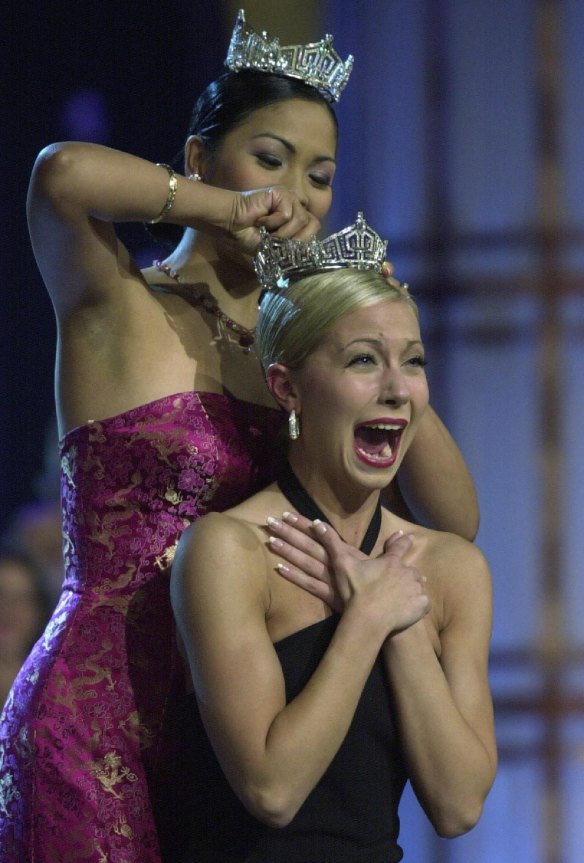 Miss America 2002, Katie Harman from Oregon (front), is crowned by Miss America 2001, Angela Perez Baraquio, at the Pageant in Atlantic City New Jersey, September 22, 2001.