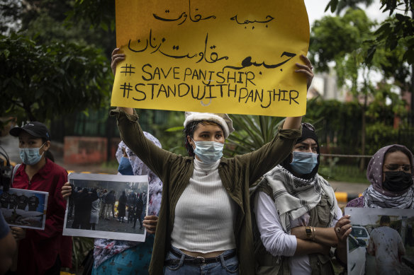 Afghan women hold placards during a protest against Pakistan and the Taliban takeover of Afghanistan.