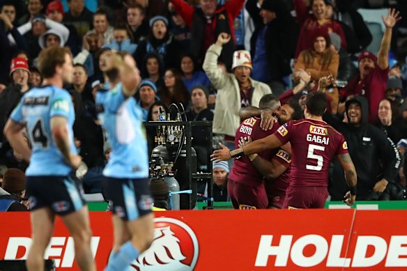 Darius Boyd of the Maroons celebrates scoring a try.