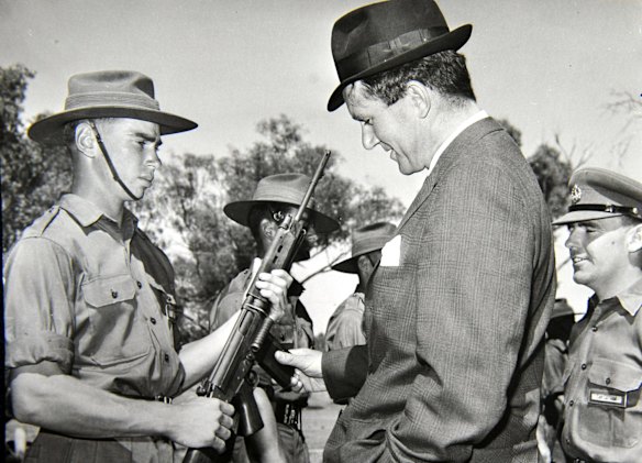 Former Prime Minister Malcolm Fraser inspects the rifle of of Duntroon Cadet G.R. Webb. (9/2/66)