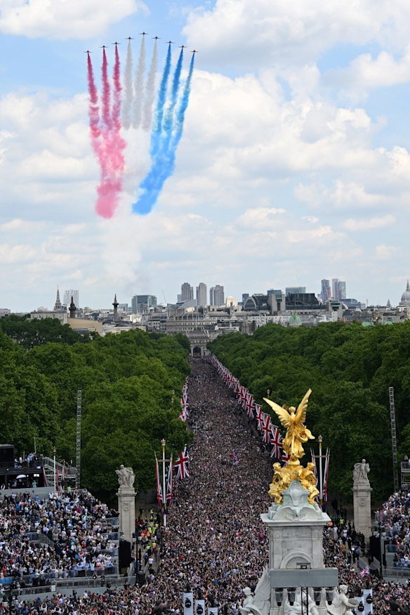 The Royal Air Force aerobatic team, the Red Arrows, fly over Buckingham Palace.